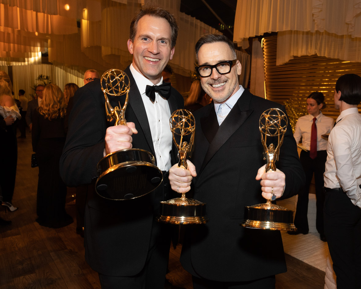 Luke Lloyd-Davies and David Furnish, executive producers of Elton John Live: Farewell from Dodger Stadium, pose with their Emmy Awards at The Walt Disney Company’s post-Emmys party.