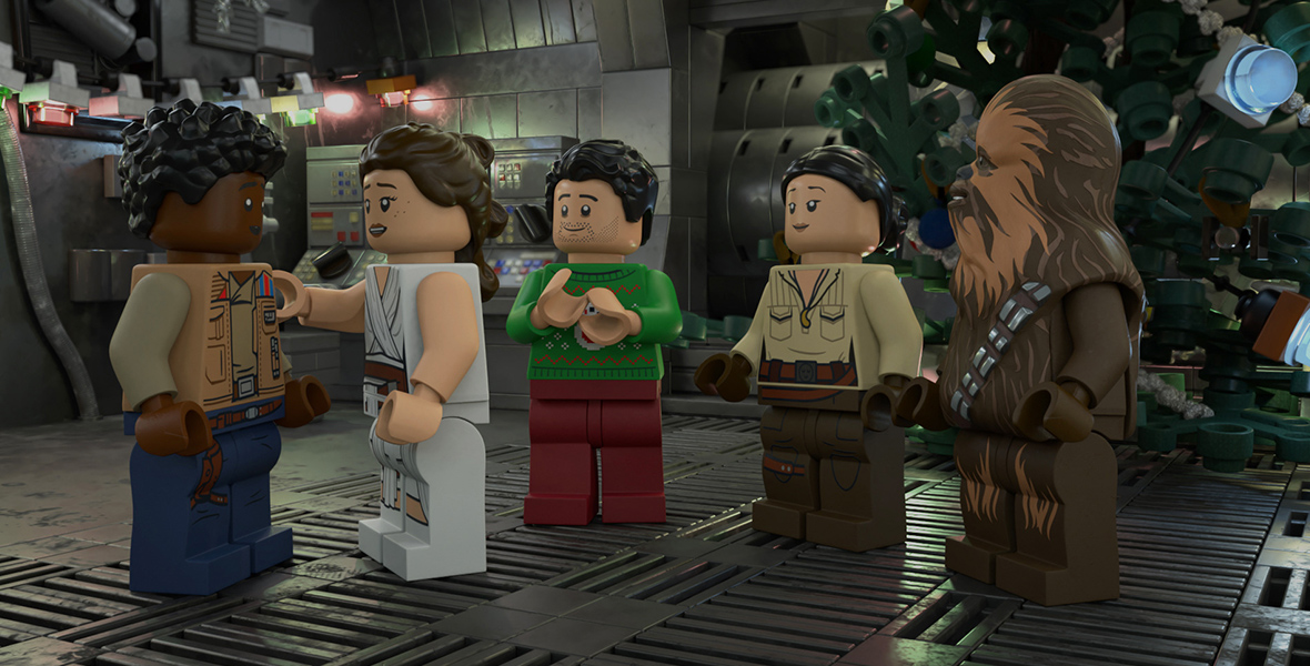 In an image from the LEGO Star Wars Holiday Special, several characters—including Rey and Chewbacca—are standing inside a ship.